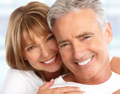 A smiling couple happy with their cosmetic dental procedures