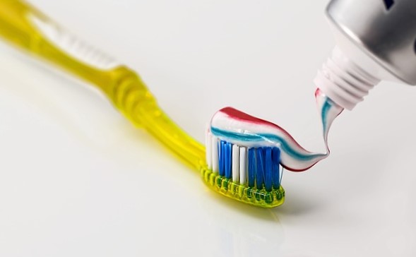A toothbrush and a colorful toothpaste