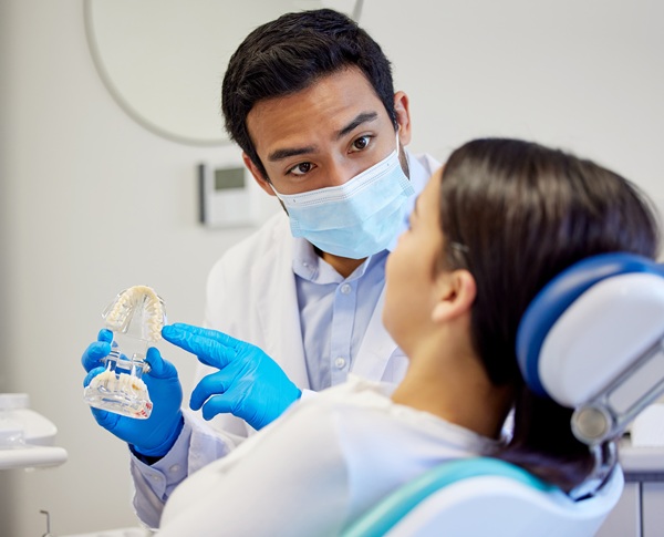 Dentist explaining composite bonding to a female patient