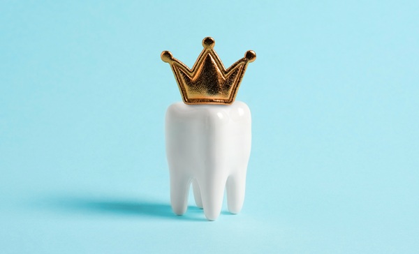 Tooth in the crown on blue background.